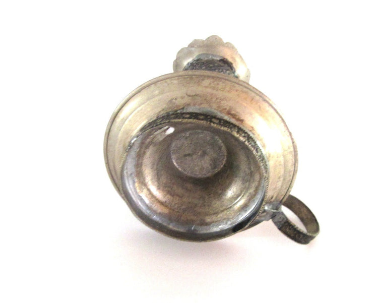 Vintage silver plated metal and glass candle holder. Shaped as an antique oil lamp. Ornate candlestick with handle.