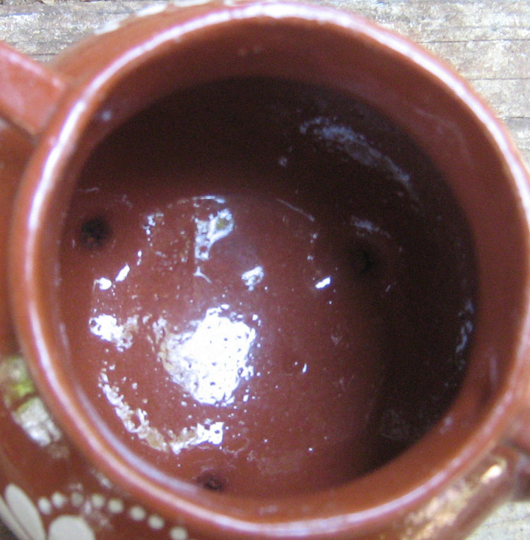 Portuguese handmade floral pottery. Made in Cabo da roca. Brown ceramics with white inscription.
