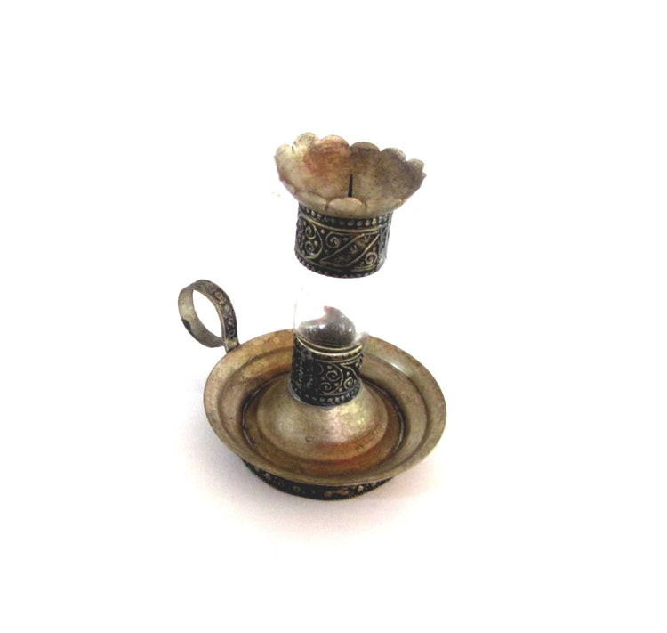 Vintage silver plated metal and glass candle holder. Shaped as an antique oil lamp. Ornate candlestick with handle.