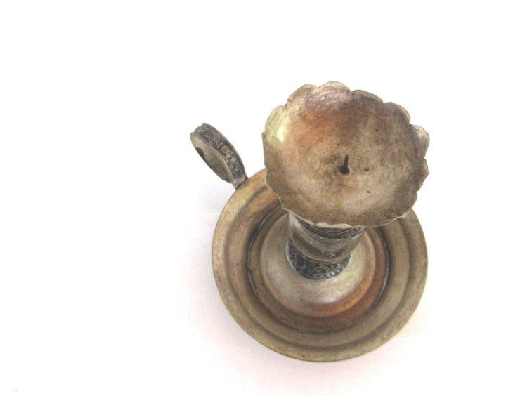 Vintage silver plated metal and glass candle holder. Shaped as an antique oil lamp. Ornate candlestick with handle.