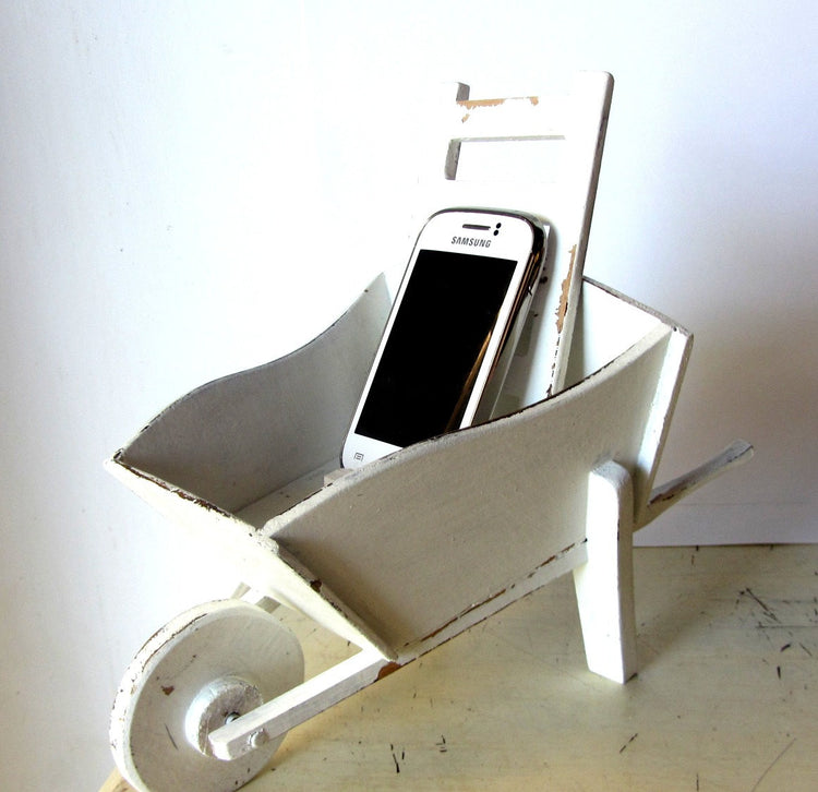 Cell phone charging station. Hand made wood wheelbarrow. White distressed shabby wooden charging station.