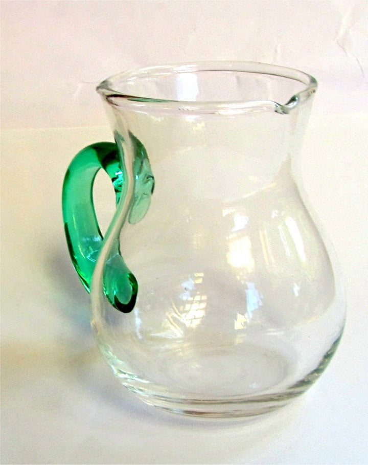 Hand blown glass creamer. Glass pitcher. Clear glass creamer. Small pitcher with green glass handle. Vintage.